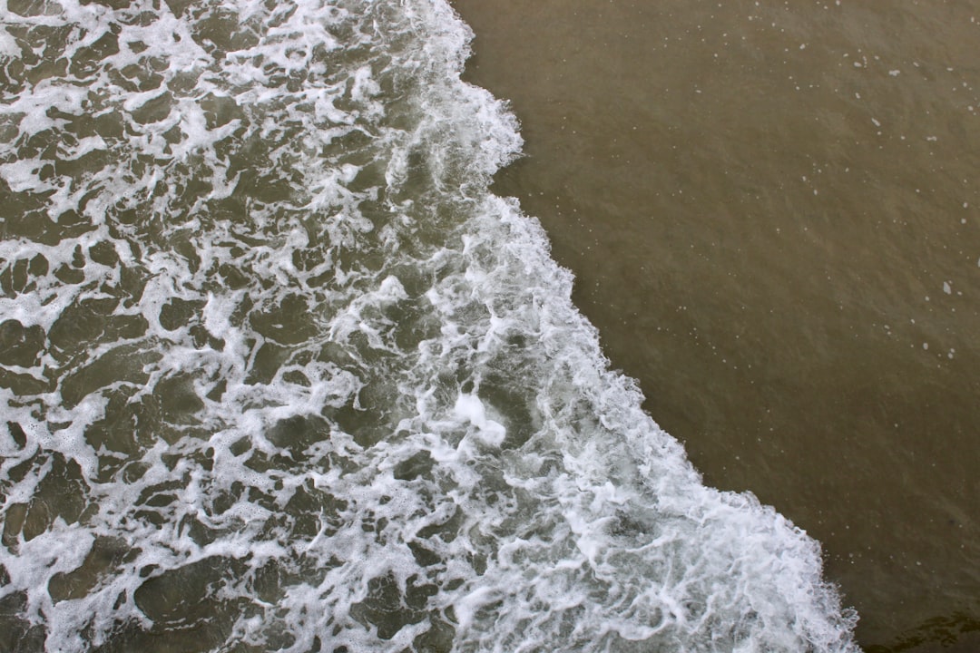 Ocean waves gently washing over sandy beach