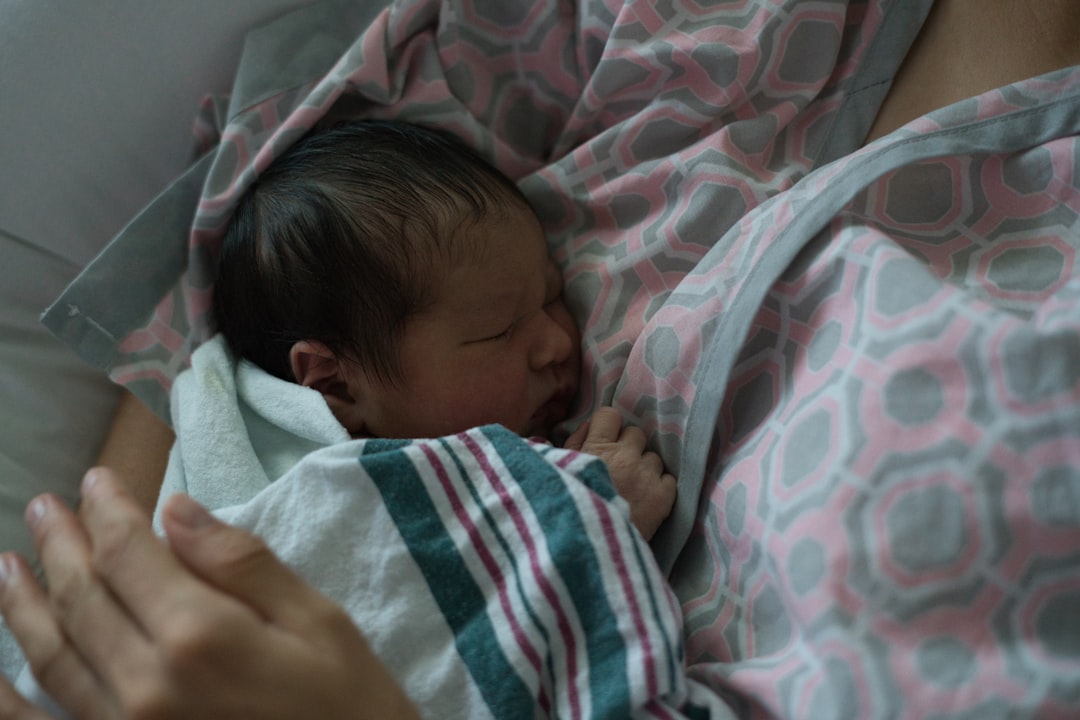 Newborn baby sleeping peacefully on a parent.