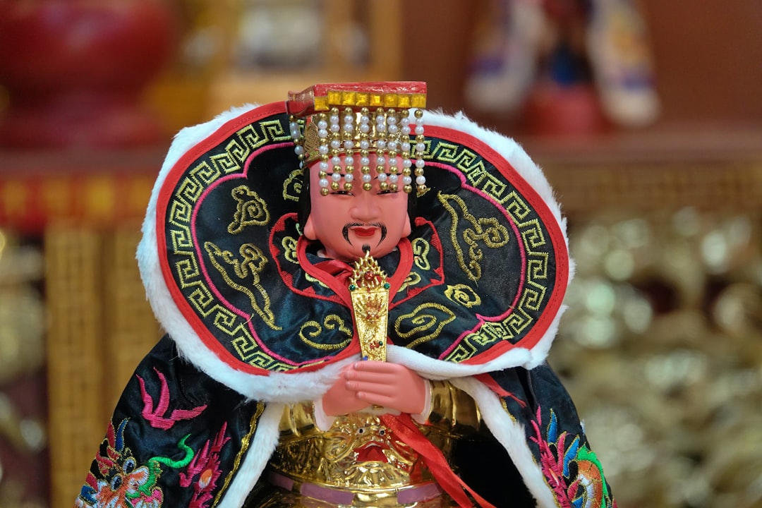 A traditional chinese deity statue with ornate headdress.