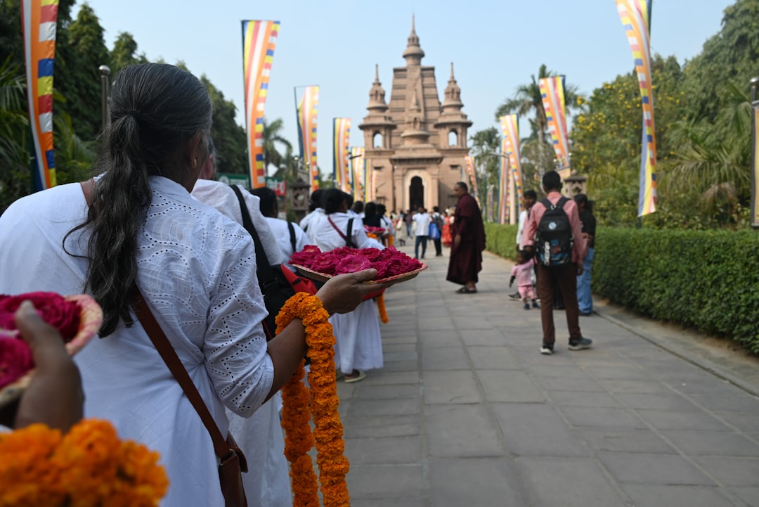 People walking towards a temple with offerings