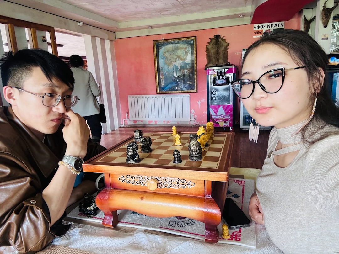 Two people playing chess at a table.