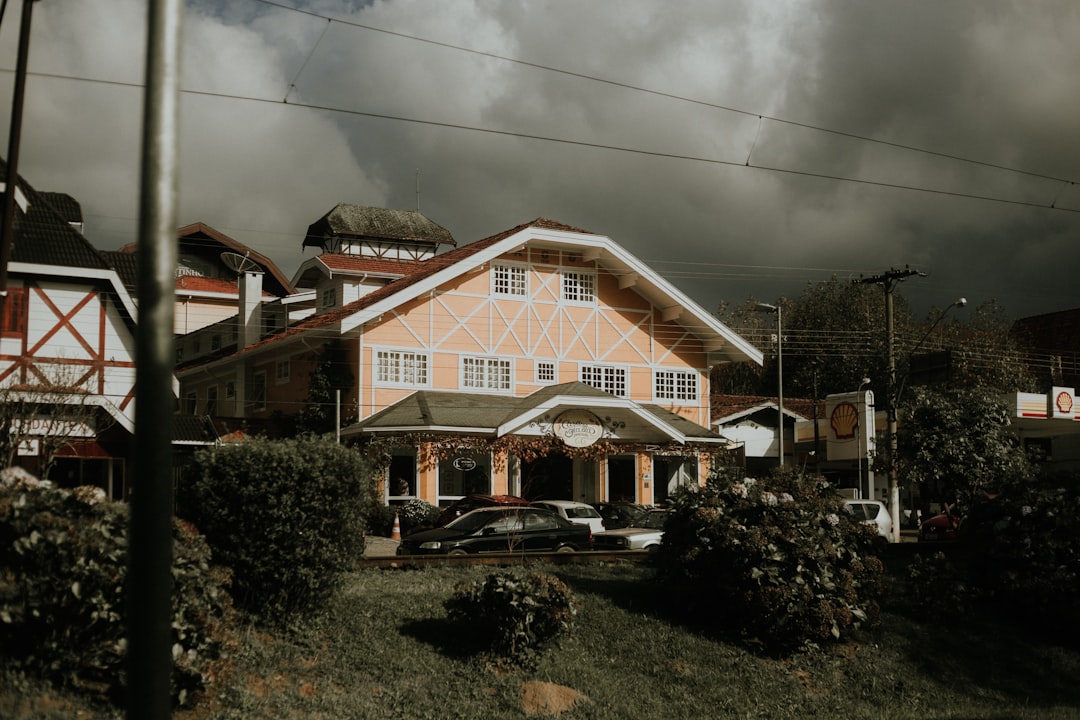 white and brown concrete house under gray sky