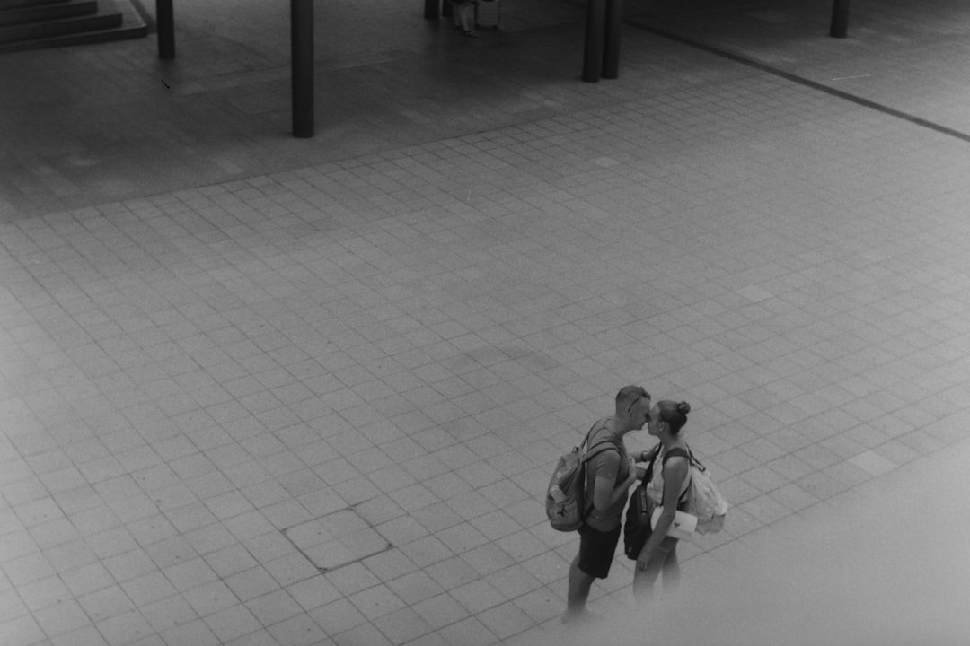 grayscale photo of kissing man and woman