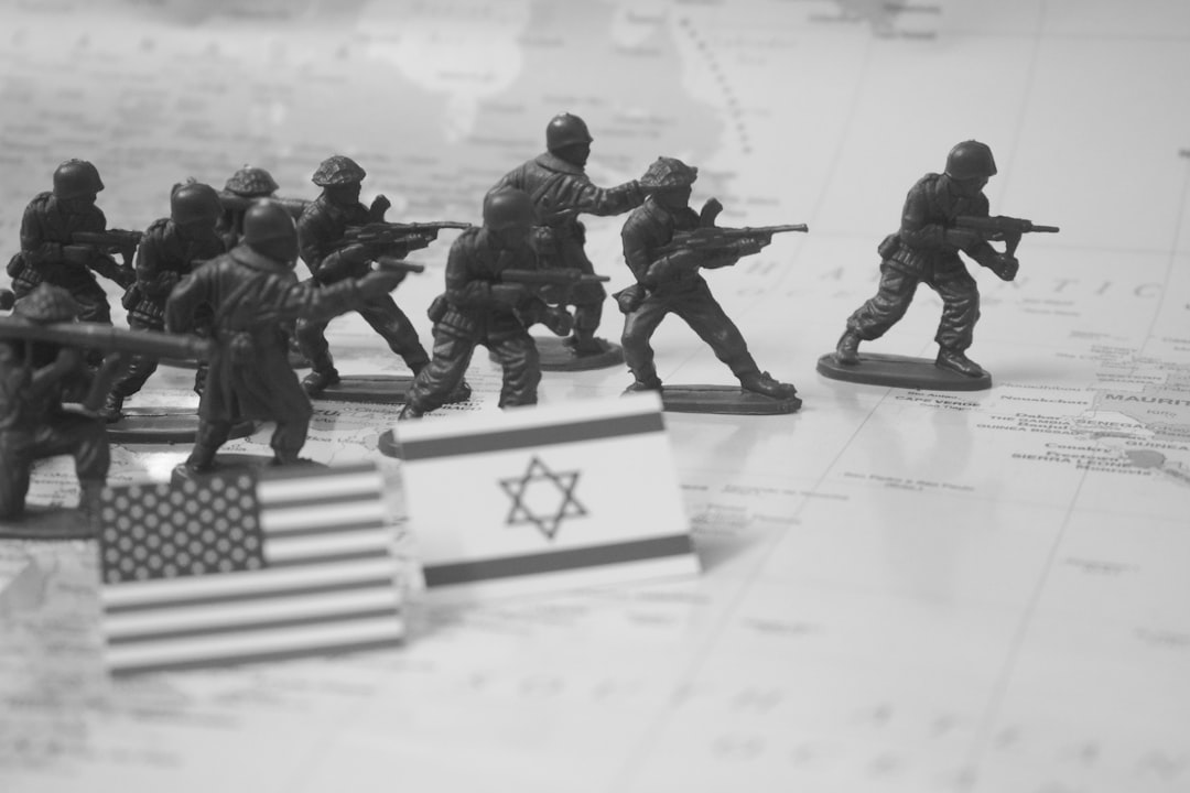 Toy soldiers advance near us and israeli flags.