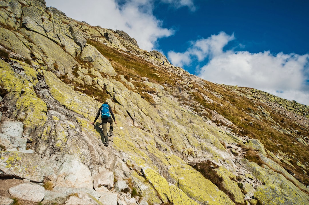 a man climbing up the side of a mountain