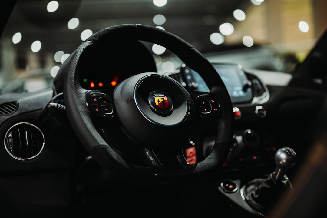 Close-up of a car's steering wheel and dashboard.