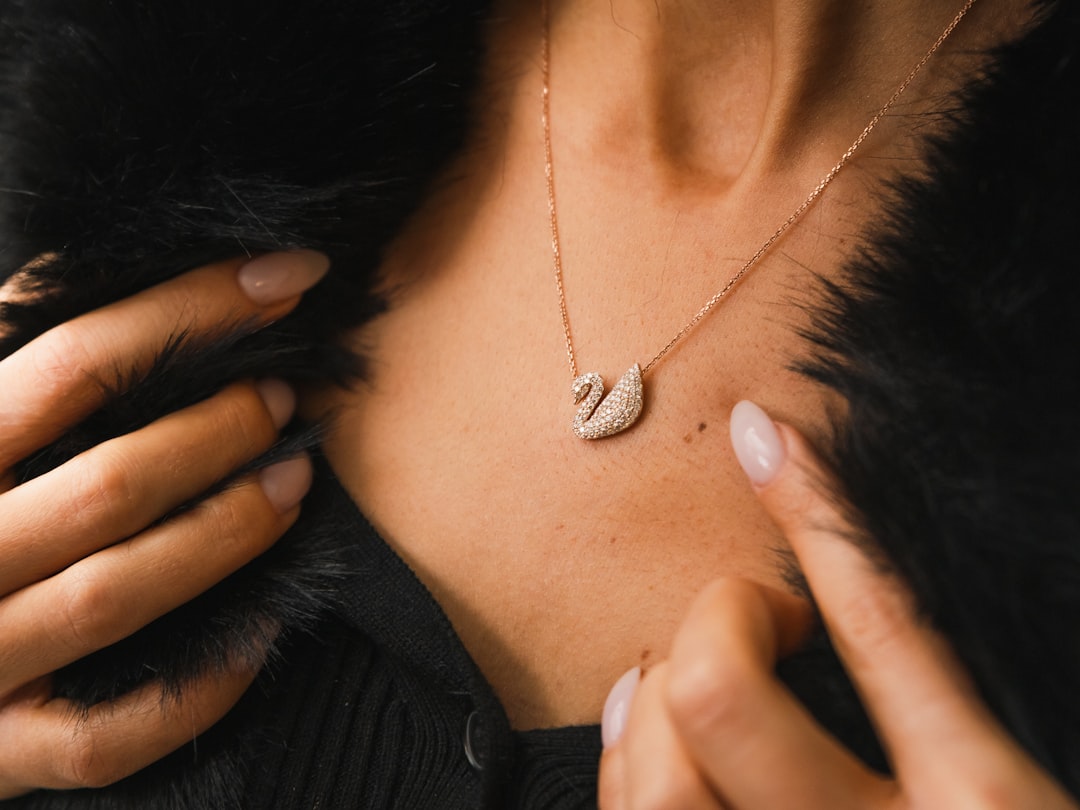 Woman wearing a swan pendant necklace